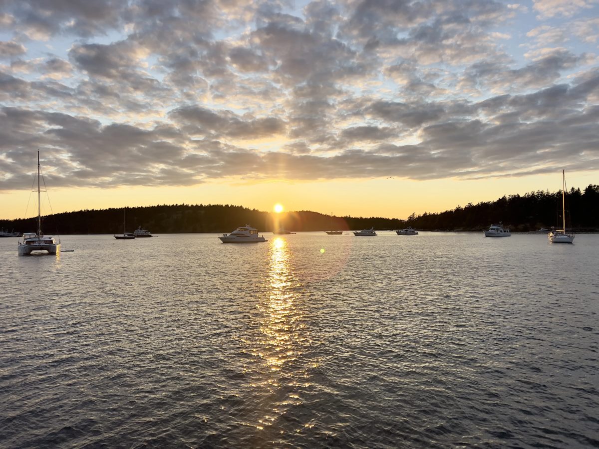 Sailboats anchored at sunset in the San Juan Islands